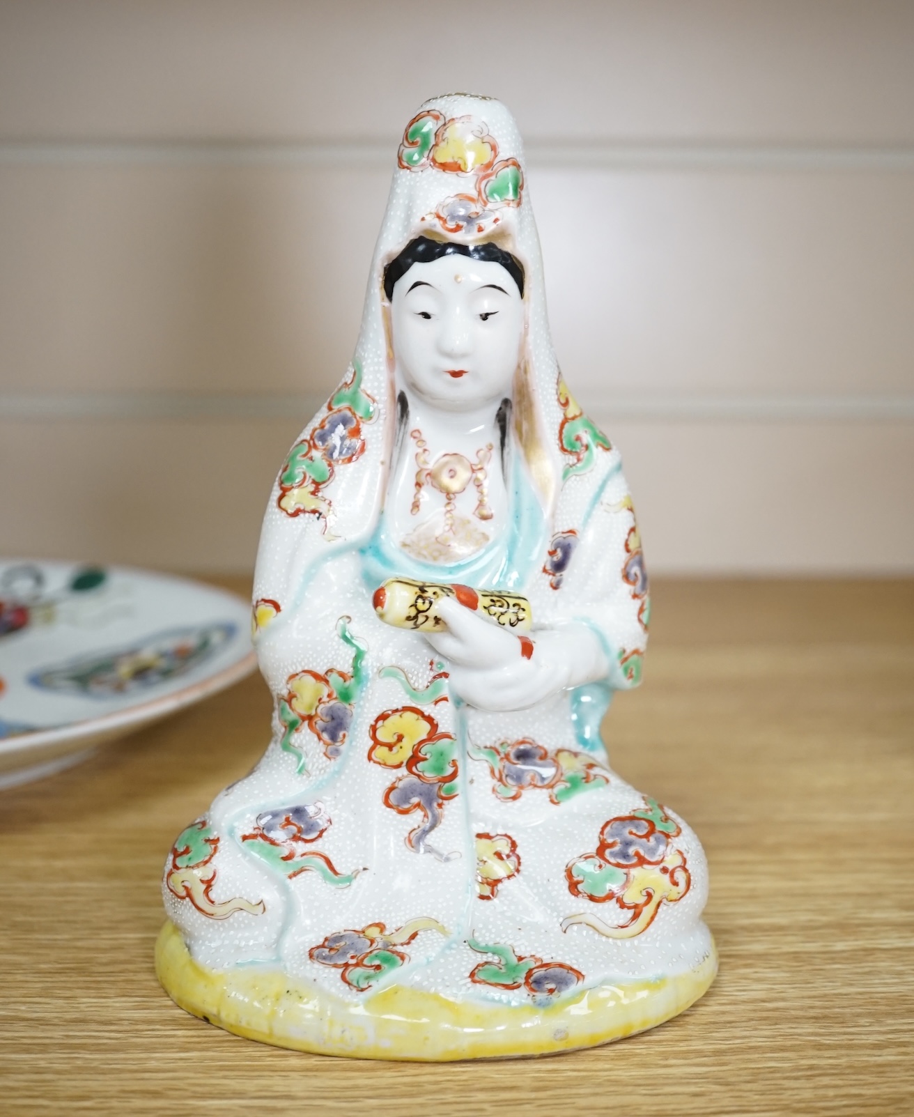 A Japanese porcelain seated figure of Kwannon, a flambé vase and a figural saucer dish, saucer dish 21.5 cm diameter. Condition - fair to good